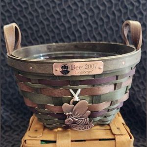 Longaberger round basket with tag and clear liner.